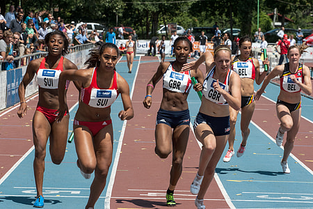 women running on the track at daytime thumbnail