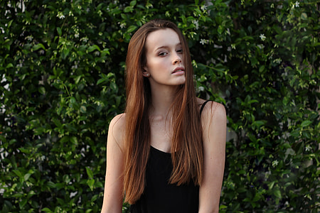 woman in black tank top near green plants thumbnail