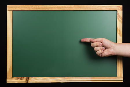 person with index finger on chalkboard digital wallpaper thumbnail