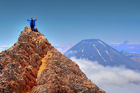 person standing on brown rock thumbnail