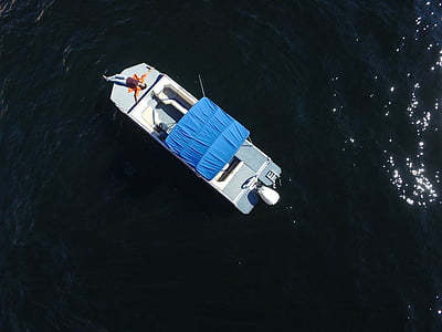 gray and blue boat on body of water thumbnail