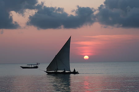 silhouette of boat on body of water thumbnail