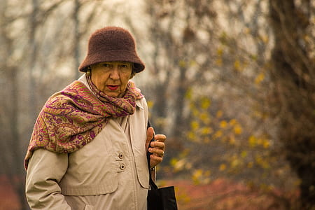 shallow focus photography of a woman holding bag thumbnail