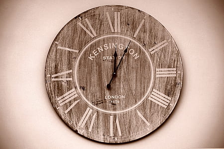 round brown analog wall clock showing 12:05 thumbnail