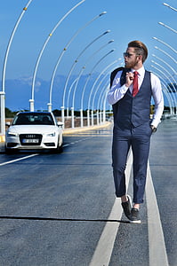 man in blue vest and dress pants thumbnail