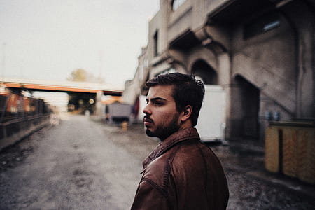 selective focus photography of man in brown jacket thumbnail