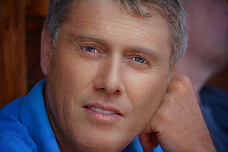 man wearing blue collared top thumbnail