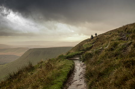 two persons hiking on hill thumbnail