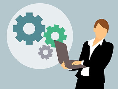 Person holding a laptop with gears of development. thumbnail