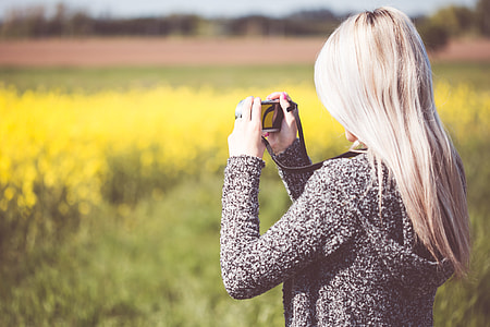 Girl Taking a Photo in Nature thumbnail