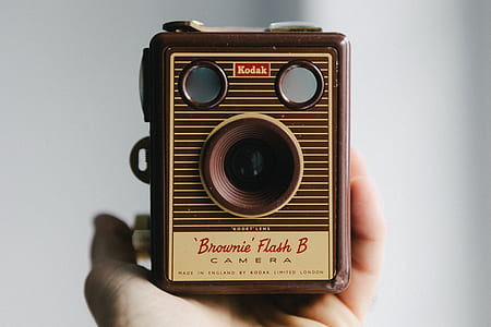 person holding brown Kodak brownie flash b camera thumbnail