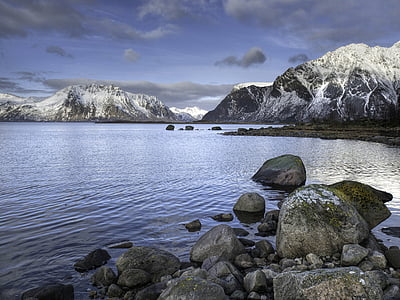 sea near glacier mountain at daytime thumbnail