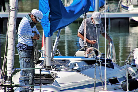 two men fixing the ropes on boat thumbnail