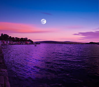 body of water within mountain range during nighttime thumbnail