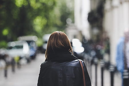 shallow focus of woman walking on the street thumbnail