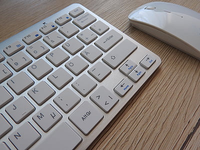 Apple Magic keyboard and mouse on top of table thumbnail