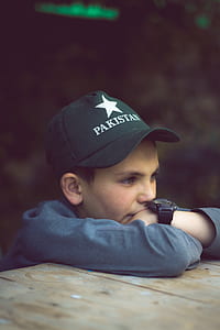 boy wearing black Pakistan cap thumbnail