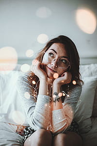 woman leaning her face on her hands smiling during daytime thumbnail