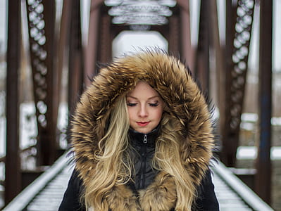 woman wearing brown and black parka hooded jacket thumbnail