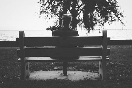 person playing violin sitting on brown wooden bench thumbnail