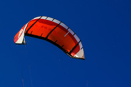 flying red, black, and white parachute thumbnail