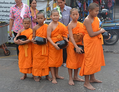 group of people wearing brown traditional dress standing on gray concrete ground thumbnail