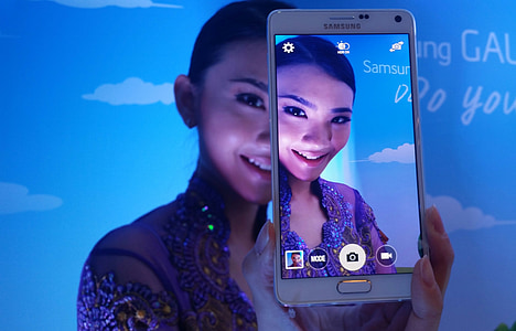 person taking photo using white frost Samsung Galaxy Note 4 thumbnail