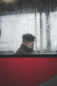 man sitting inside vehicle with moist glass thumbnail