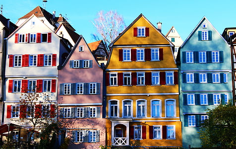 assorted-color houses surrounded by trees during daytime thumbnail