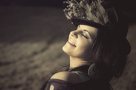 woman with black and gray flower accent hat close-up photography thumbnail