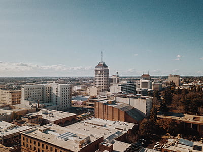 aerial view photography of white and brown concrete high-rise building at daytime thumbnail