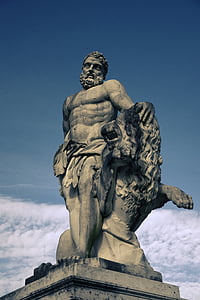 man sitting on stone statue thumbnail