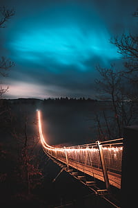 photography of bridge with lights during night time thumbnail