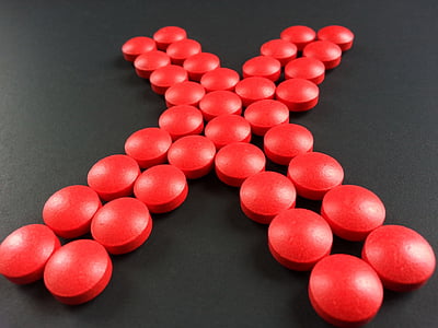 round red medication pill forming X thumbnail