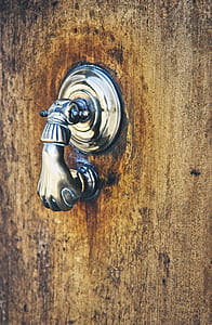gray stainless steel door knob on brown wooden surface at daytime thumbnail