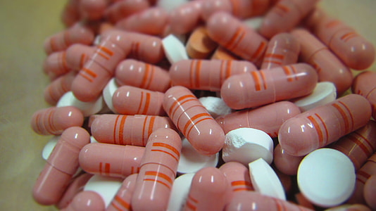 pink capsules and white medication tables thumbnail