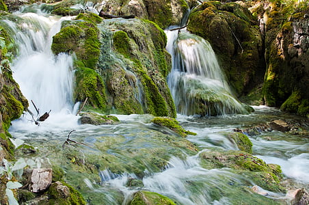 green rocky river at daytime thumbnail
