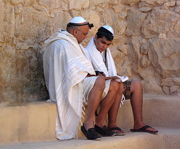 man reading book with a boy outdoors thumbnail