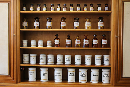 assorted bottles on brown wooden shelf thumbnail