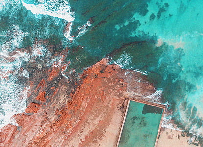 aerial photography of rock formation near sea thumbnail