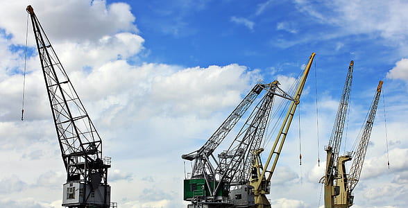 three tower cranes standing beside each other thumbnail