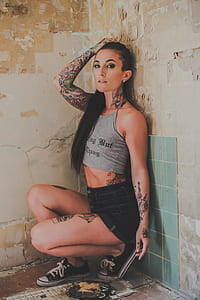 woman sitting in corner of room thumbnail