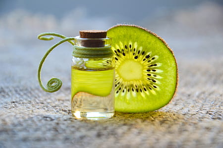 kiwi fruit and clear glass bottle thumbnail