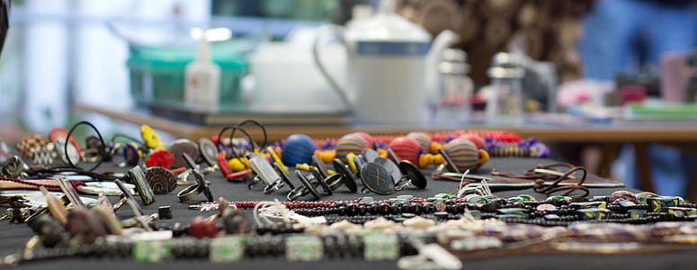 assorted jewelries on black table thumbnail