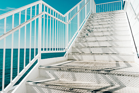 close up photo of stairs near body of water thumbnail