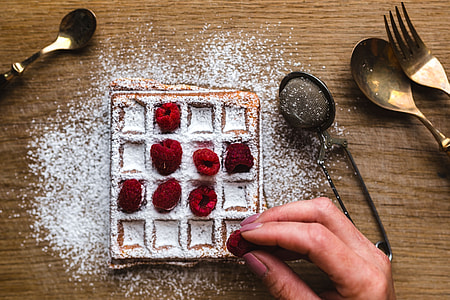 Breakfast waffles with fresh raspberries and powdered sugar thumbnail