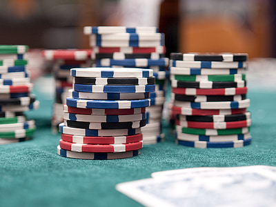 assorted poker chips on green surface thumbnail