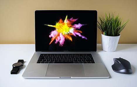 silver MacBook Pro with black cordless mouse thumbnail
