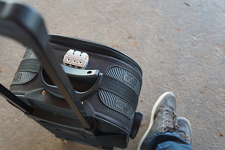 black softside luggage placed on floor next to feet thumbnail