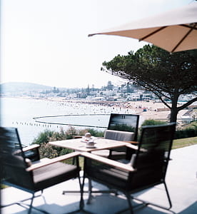 square gray patio table with chairs during daytime thumbnail